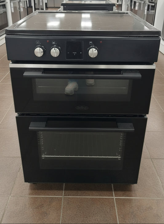 Black double oven with glass cooktop on a white background